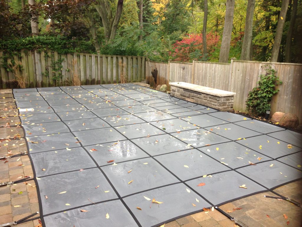 Pool safety cover with leaf debris